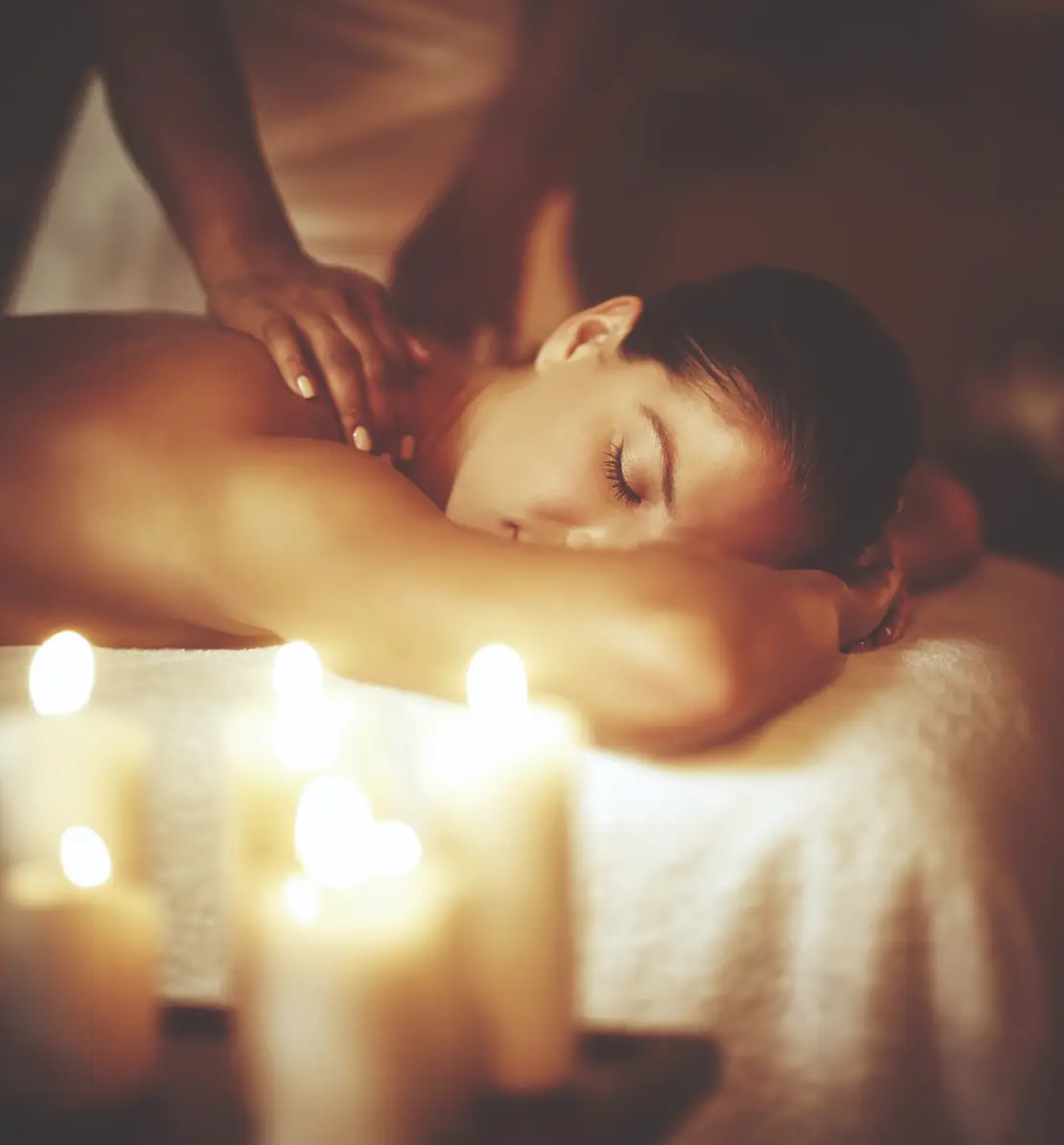 Lady having a massage surrounded by candles at Homefield Grange