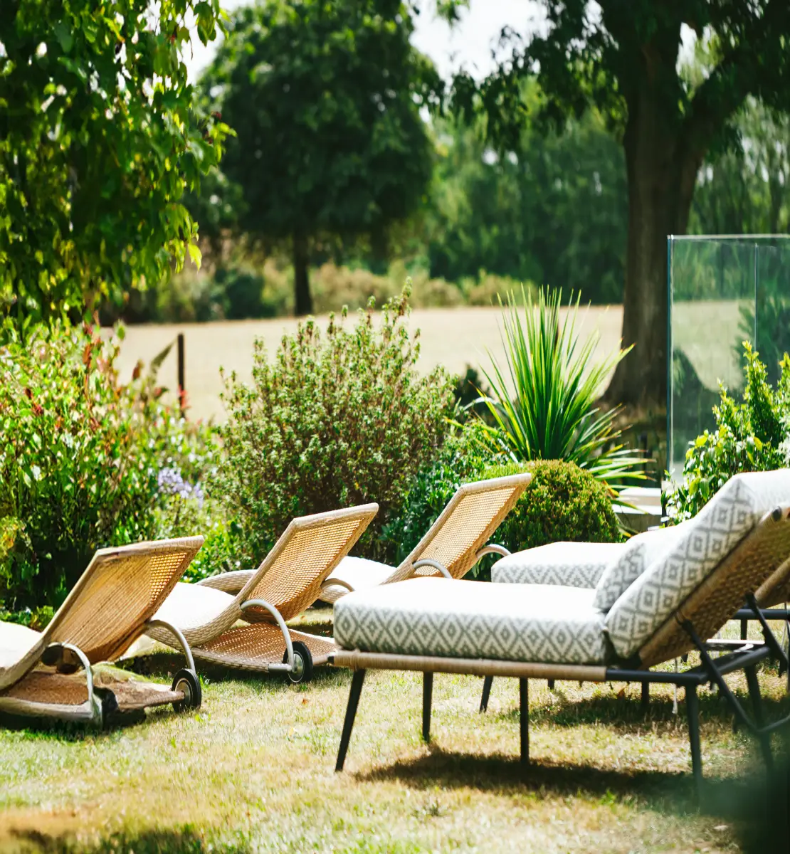 Outdoor relaxation loungers set within the spa garden, offering a calm space to rest and unwind during a wellness spa day.