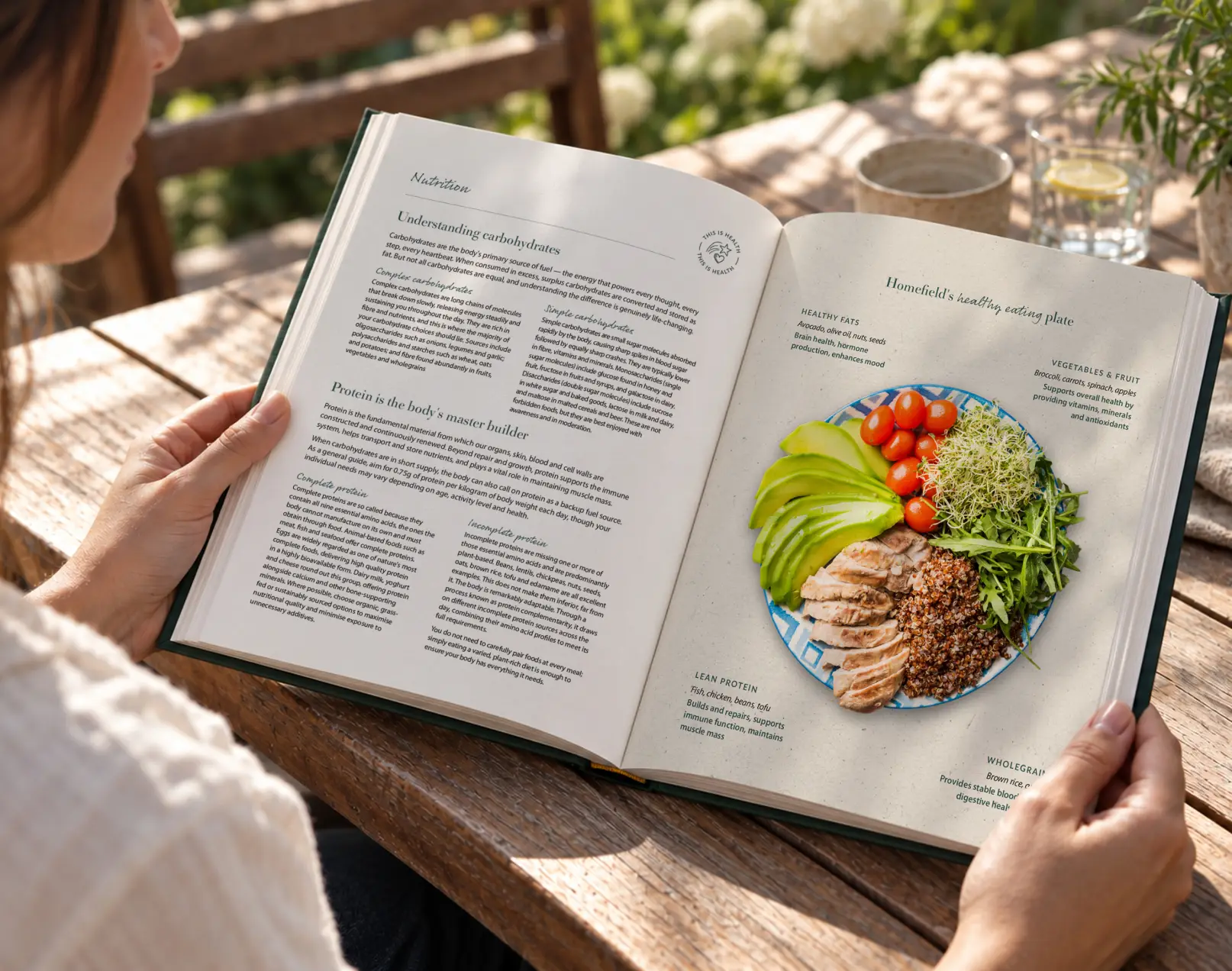The Homefield Way cookbook being read outdoors, open to the nutrition section